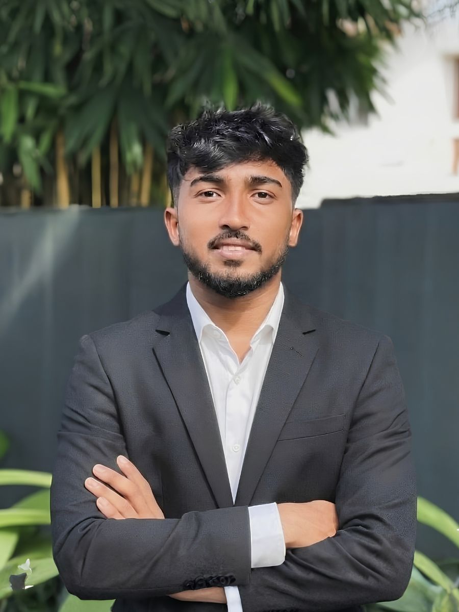 Wishva in a portrait wearing a dark suit
